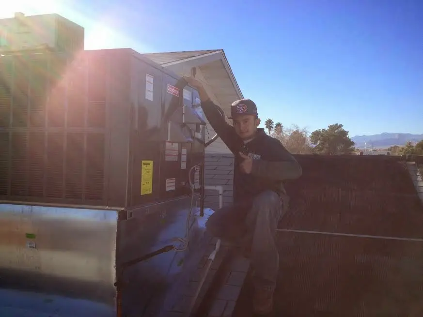 HVAC technician performing HVAC Inspection on a rooftop unit in Tyrone